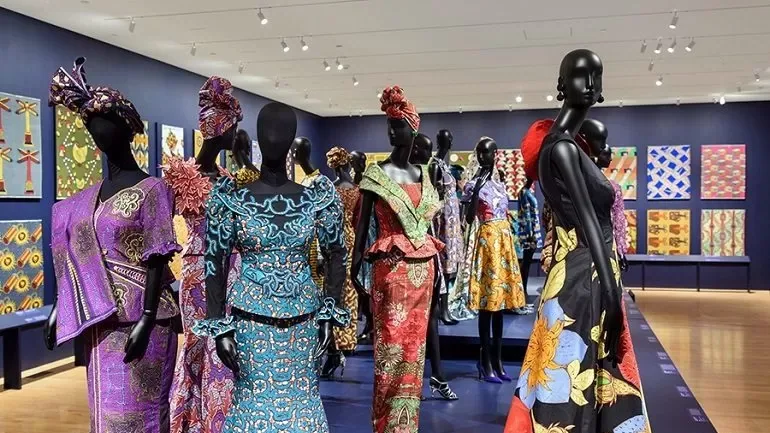 Wax-print dresses displayed on mannequins at a fashion exhibition