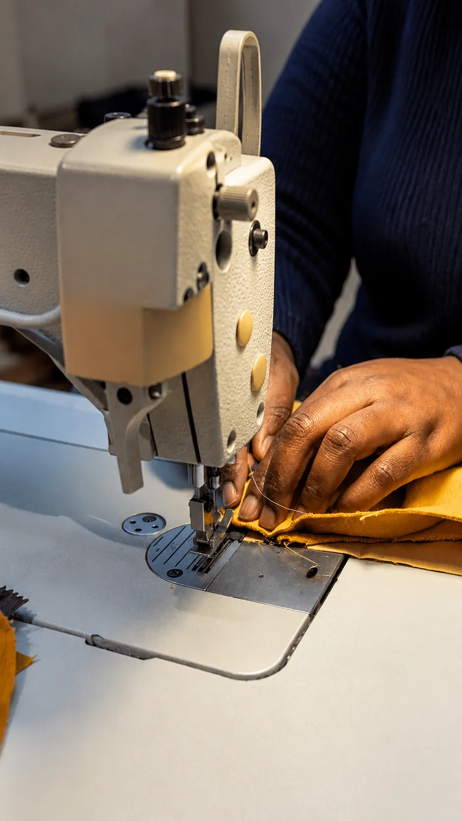 Apprentice learning to sew under a master tailor